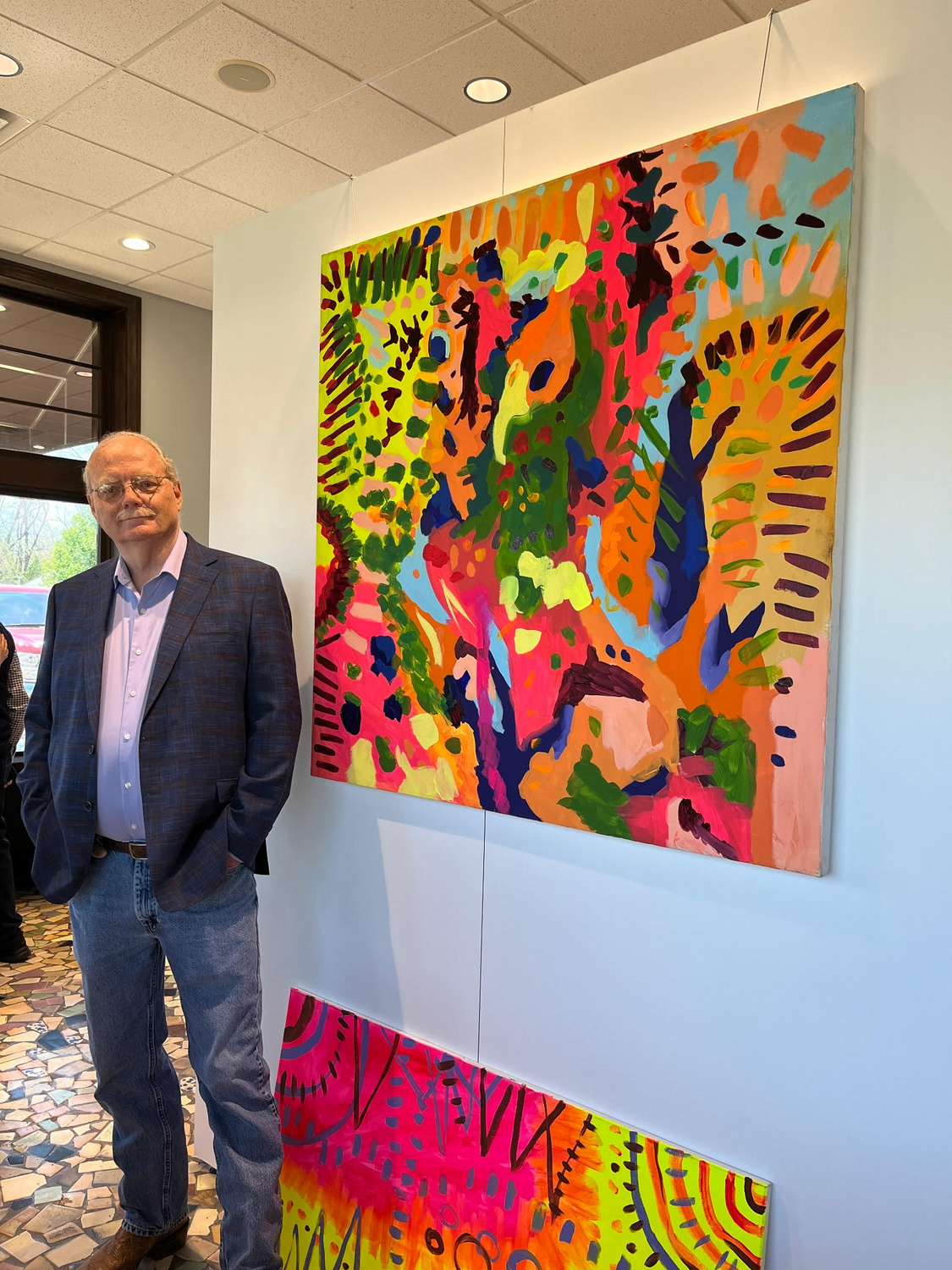 Kim Bienash at the AIM arts exposition with local artist Wendy Kim's painting